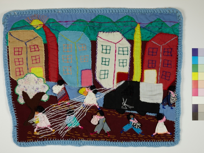 An Arpillera showing a police truck spraying people in a city